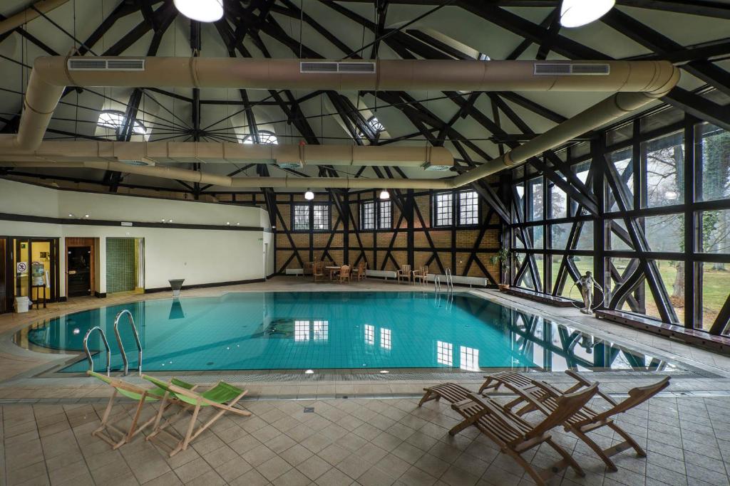 Spacious indoor pool area with large windows and seating.