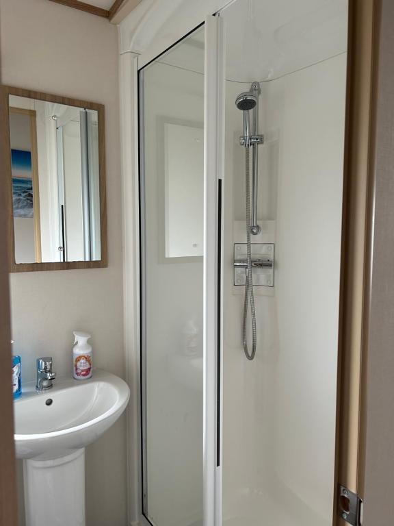 a bathroom with a shower and a sink at Uisge Beatha in Dornoch