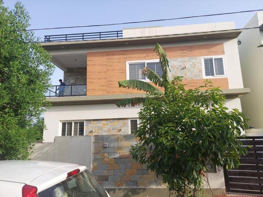 a man standing on the balcony of a house at Diva Villa in Dabok