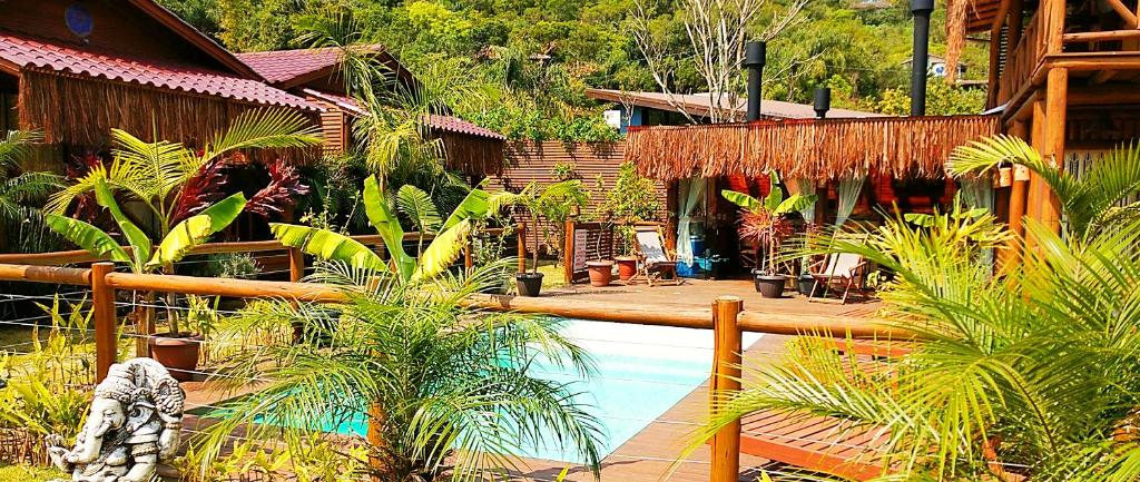 a resort with a swimming pool and some plants at ॐ Rosa Astral ॐ in Praia do Rosa