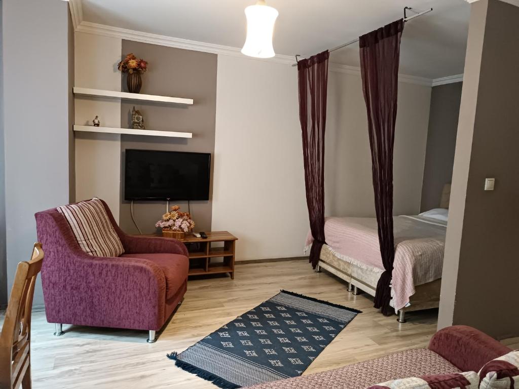 a living room with a couch and a bed at The City Residence Hotel in Canakkale