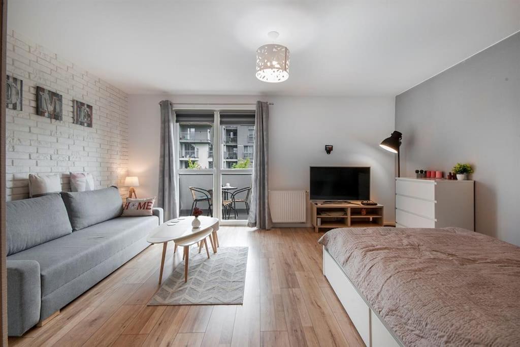 a living room with a couch and a table at Funcional Condo- Kraków bezpłatne miejsce w garażu in Kraków