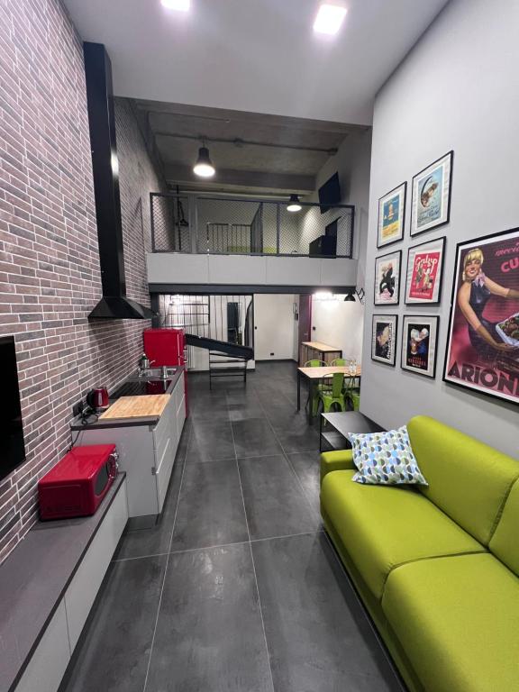 sala de estar con sofá verde y cocina en Residence Star, en Turín