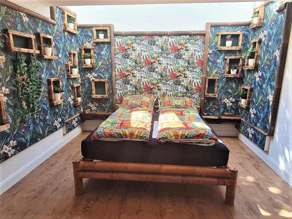 a bed in a room with a wall with paintings at Welcome to Munich by Martina in Munich