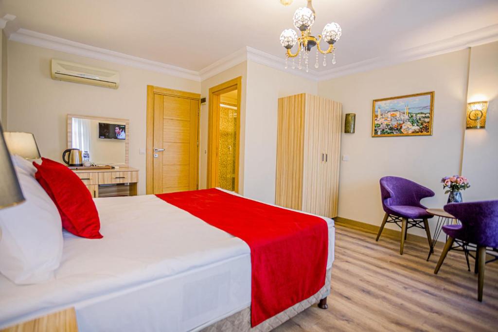 A bed or beds in a room at Gülec Konak Hotel