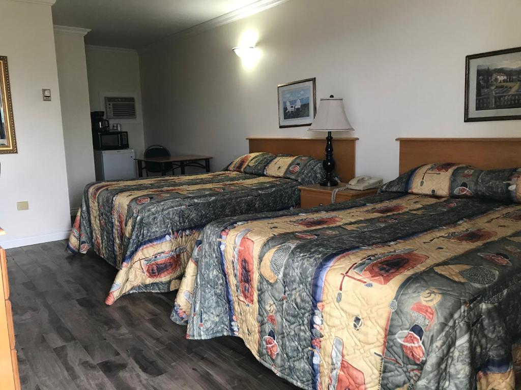 Postel nebo postele na pokoji v ubytování Grassland Motel