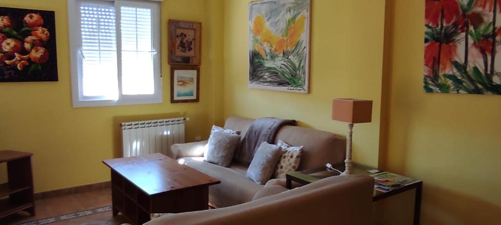 a living room with a couch and a table at APARTAMENTO PERFECTO in La Antilla