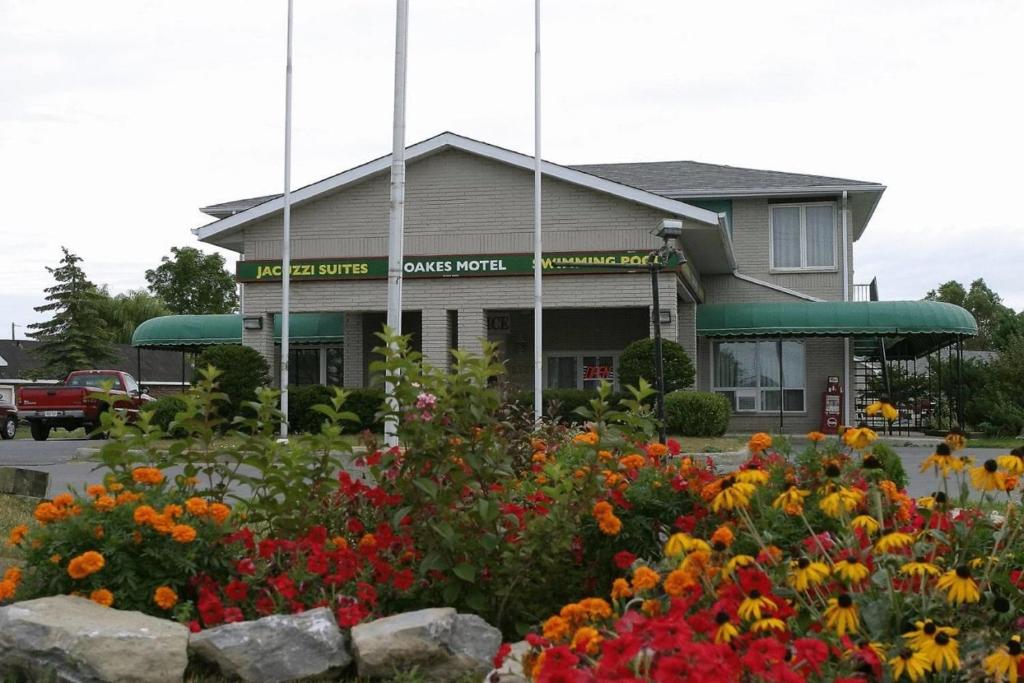 a flower garden in front of a building at Seven Oakes Motel in Kingston