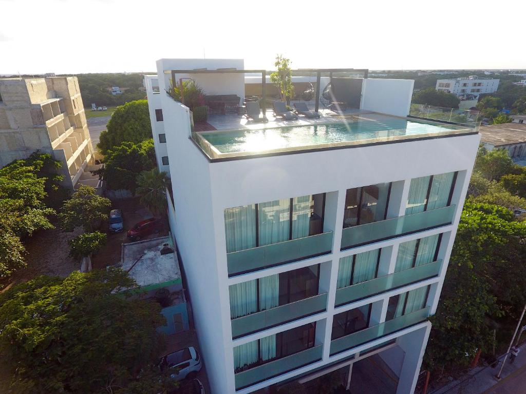a building with a swimming pool on top of it at RIVA Playa Sur in Playa del Carmen