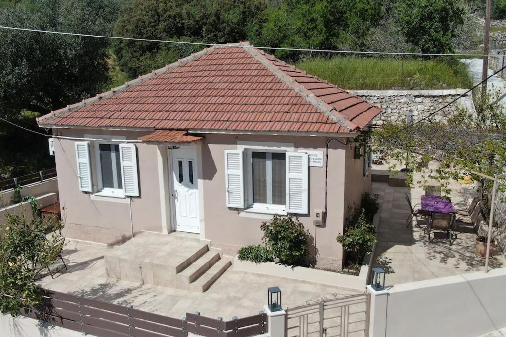 a small pink house with a red roof at Giannata House in Argostoli
