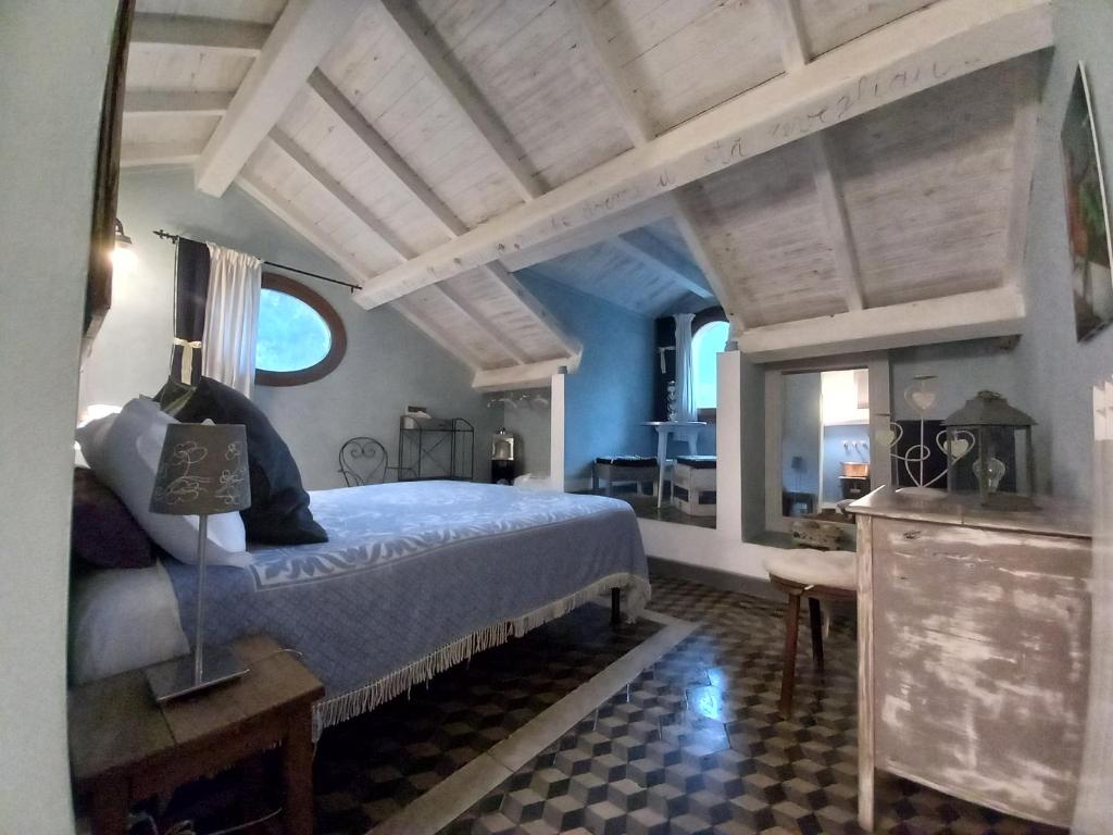a bedroom with a large bed in a room with blue walls at La Casa Rosa in Pigna