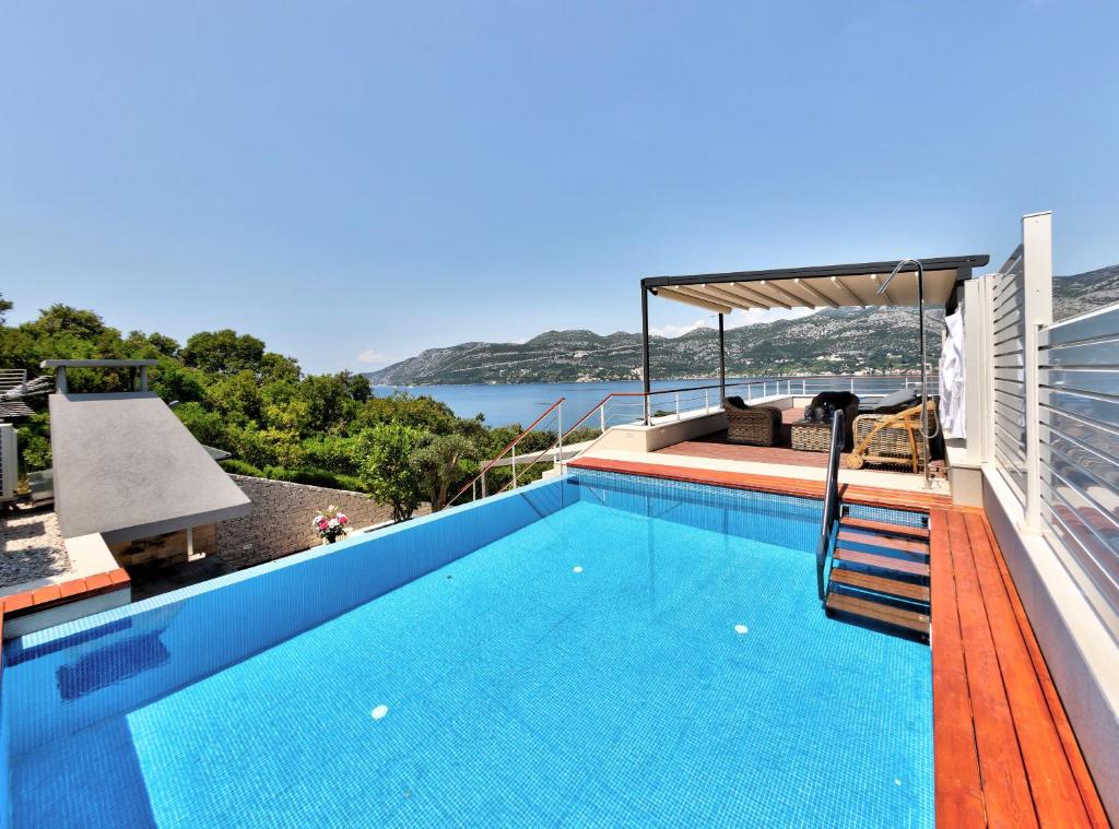 a swimming pool with a view of the water at Villa Soul Sisters in Korčula
