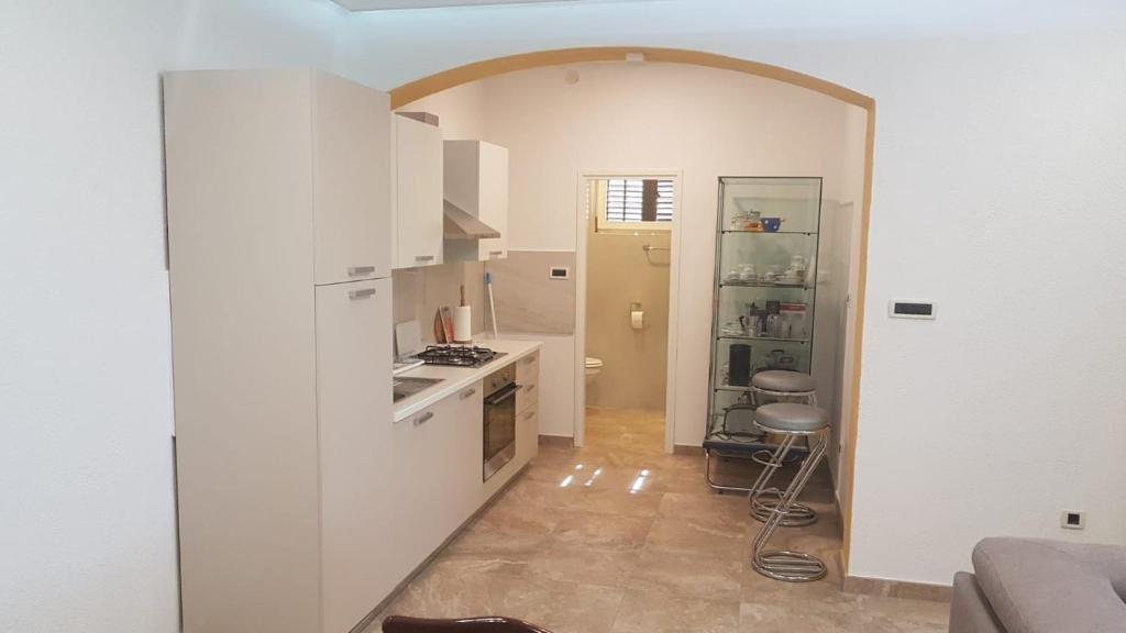 a kitchen with an archway leading into a room at APARTMAN ROSEMARY in Rijeka