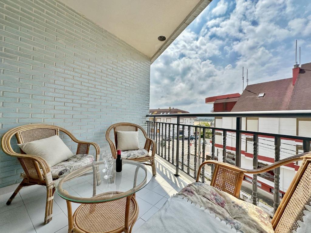 a balcony with a glass table and chairs on it at Isla Mar - 5833 in Isla