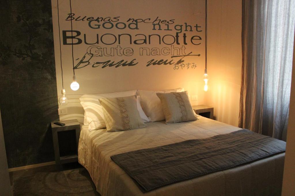 a bedroom with a bed with a poster on the wall at Vittorio Veneto 25 in Modena