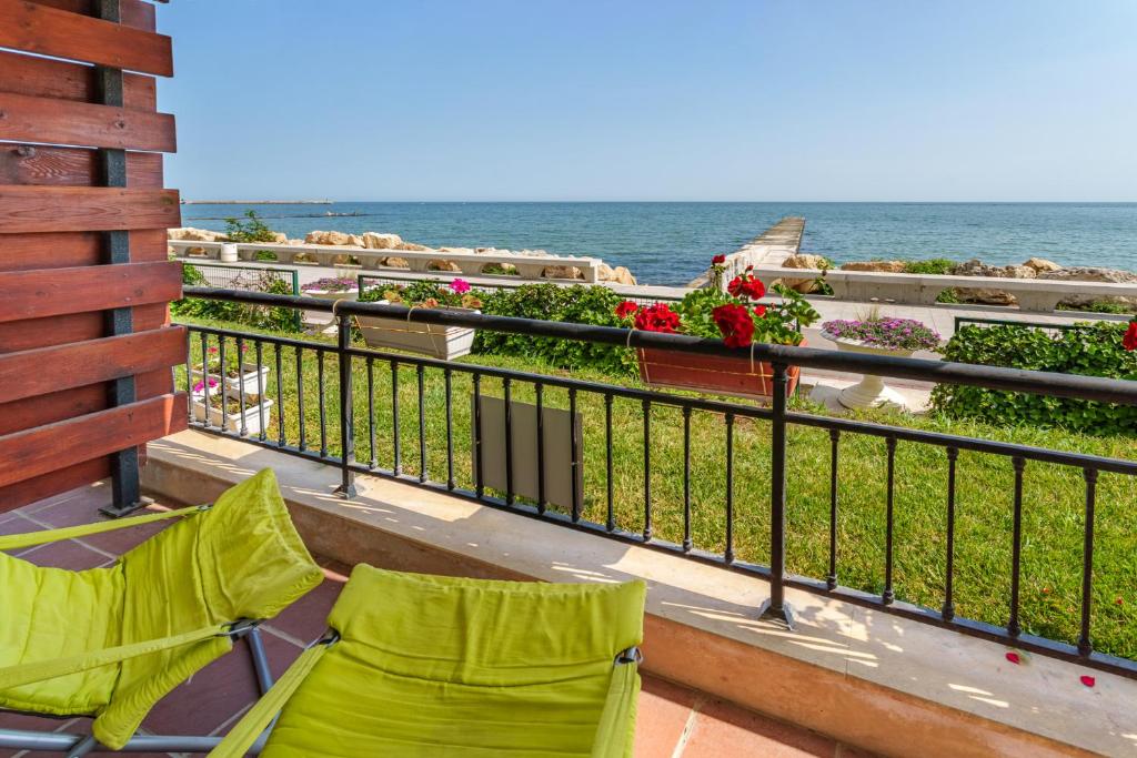 balcón con 2 sillas y vistas al océano en Apartment Poemia, complex Carpe Diem, private pool and free parking, en Balchik