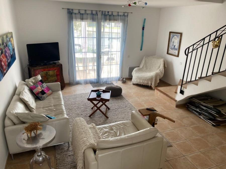 a living room with two couches and a tv at Marina 26 in Aigues-Mortes
