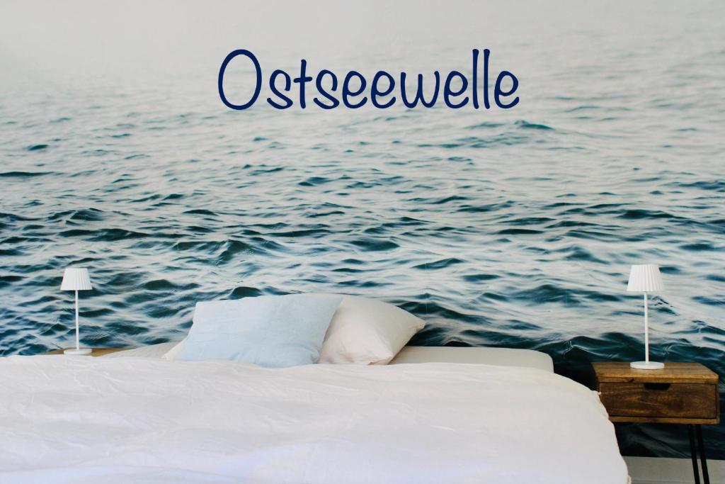 a bed in front of the ocean with the words osteologically at Ostseewelle, Parkplatz in Kiel