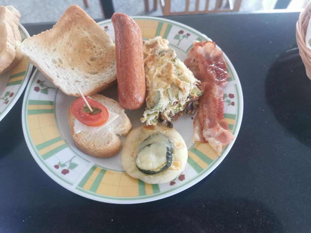 a plate of breakfast foods on a table at Astra in Agerola