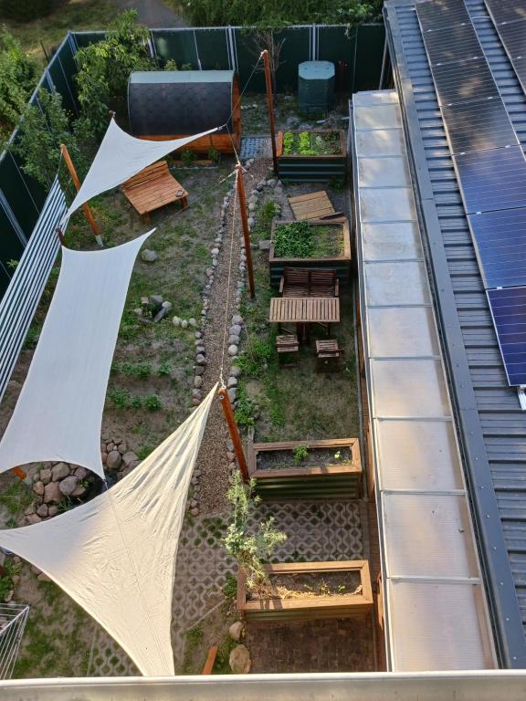 a garden with white umbrellas on top of a building at Squat Deluxe Berlin, the hostel in Berlin
