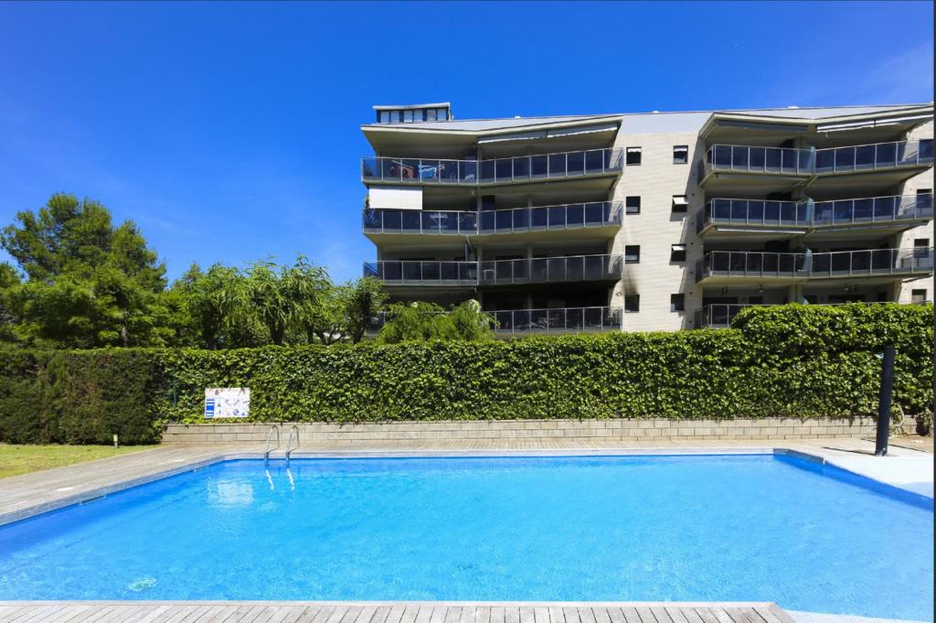 a swimming pool in front of a building at JOEL 2 Planetcostadorada ONLY FAMILIES in Salou