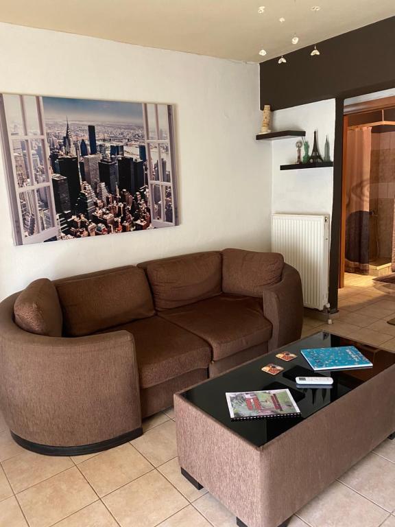 a living room with a couch and a coffee table at George Garden in Nea Michaniona