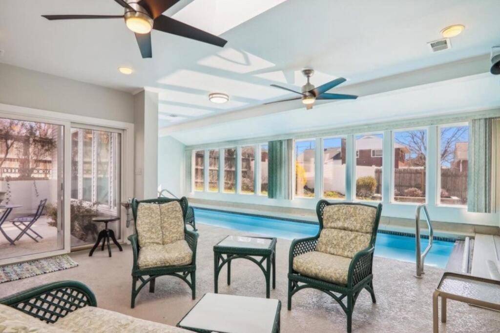 a living room with a pool and a ceiling fan at 5 bedroom w/ indoor pool/hotub in Silver Spring