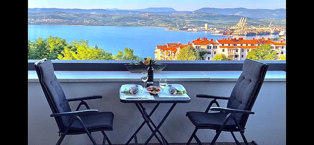 a table and chairs on a balcony with a view of the water at Lux -Luxury Sea and Mountains View Apartment-NEW in Koper