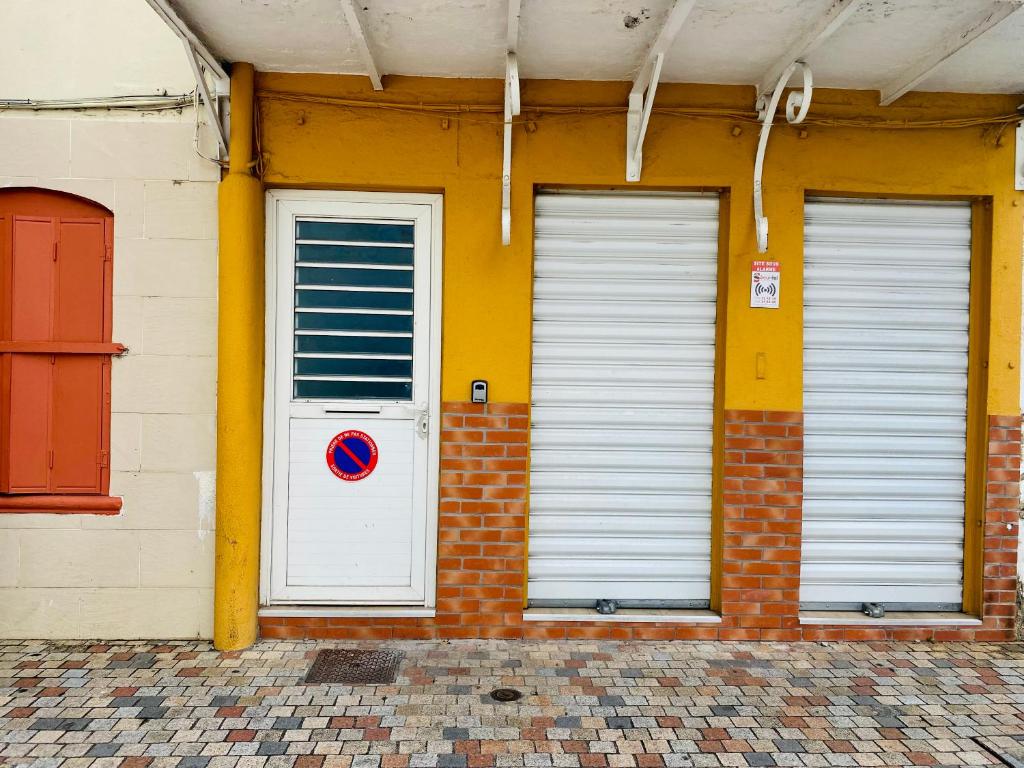 zwei Türen an der Seite eines Gebäudes in der Unterkunft FABULEUX STUDIO Centre ville Fort De France Martinique CAPITALE in Fort-de-France