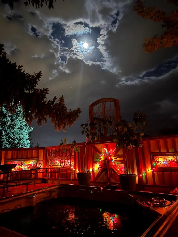 a patio lit up with christmas lights at night at Mystic Portal 420 Guesthouse in Colorado Springs