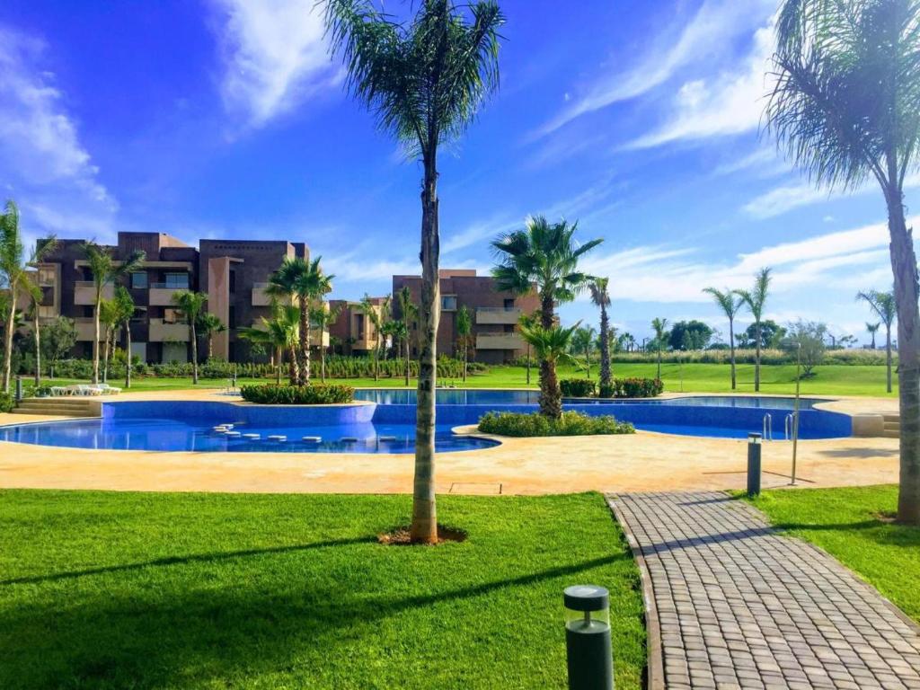 a resort with a swimming pool and palm trees at Prestigia Agate 260 in Marrakesh