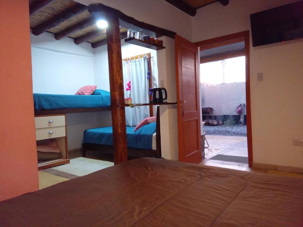 a bedroom with two bunk beds and a mirror at Crisol. in Cafayate