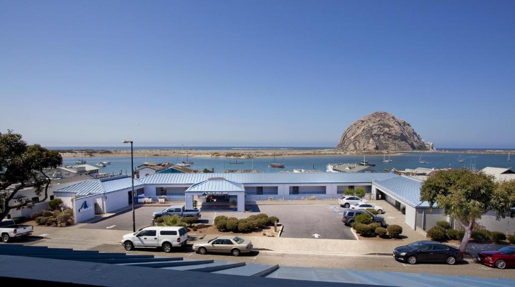 a parking lot with cars parked in front of a building at Blue Sail Inn in Morro Bay