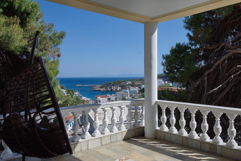 a balcony with a view of the ocean at Eleni's Guest House in Patitiri