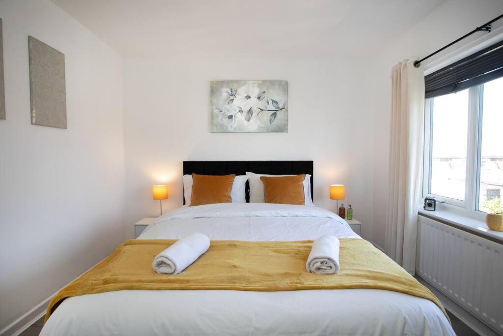 a bedroom with a large bed with towels on it at Maltby House, Rotherham for contractors & Families, free private parking, fast wifi, spacious,WIFI etc in Rotherham