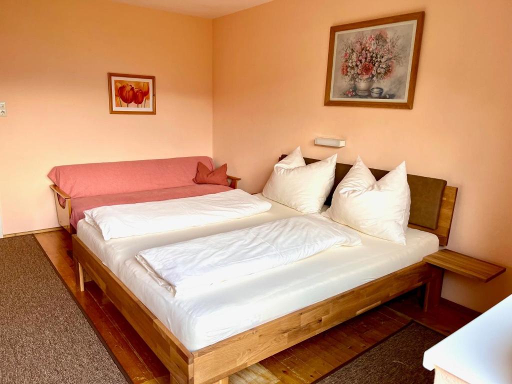 a bedroom with a bed with white sheets and pillows at Pranger Hof in Trins