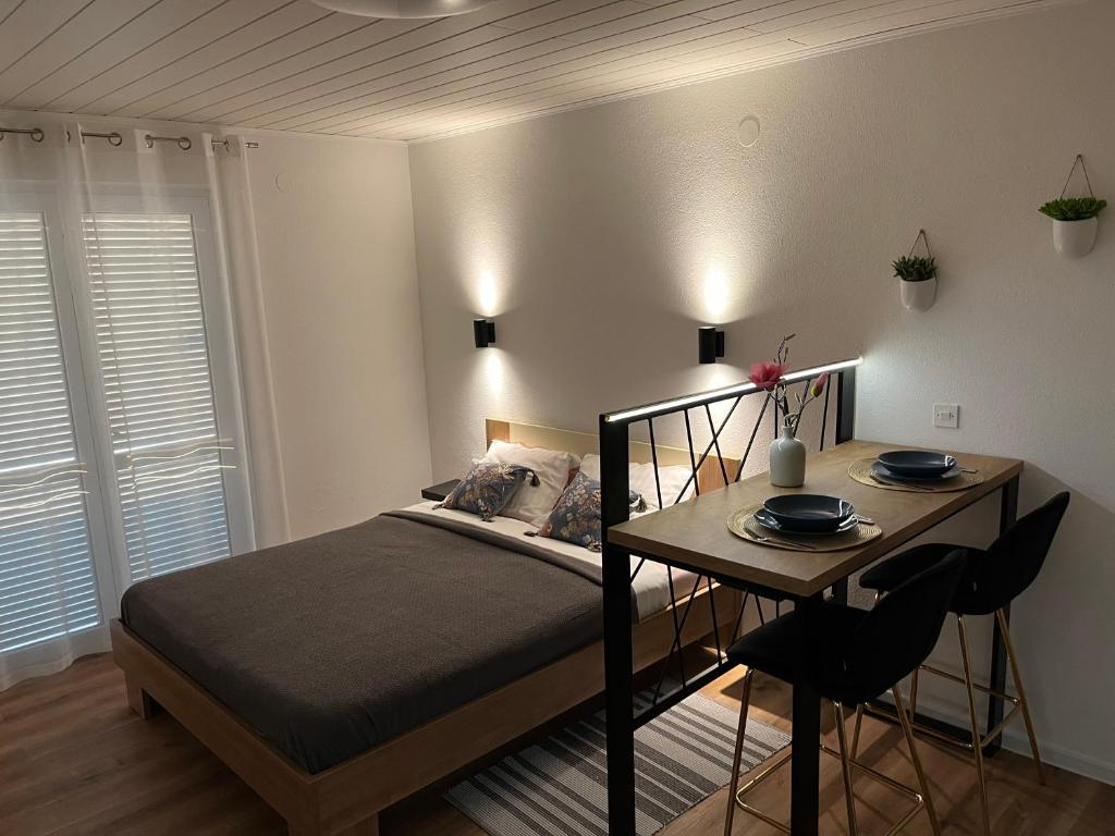 a bedroom with a bed and a table with chairs at Apartment Bagaric in Stari Grad