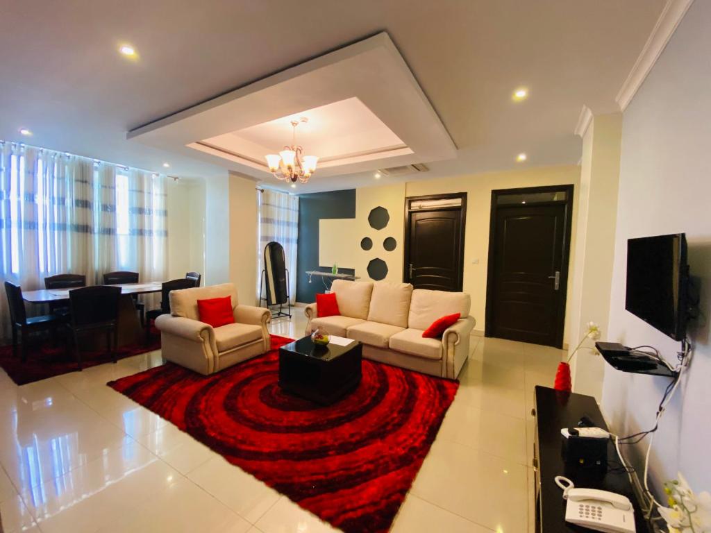 a living room with two couches and a red rug at IZA Serene city centre apartments in Kigali