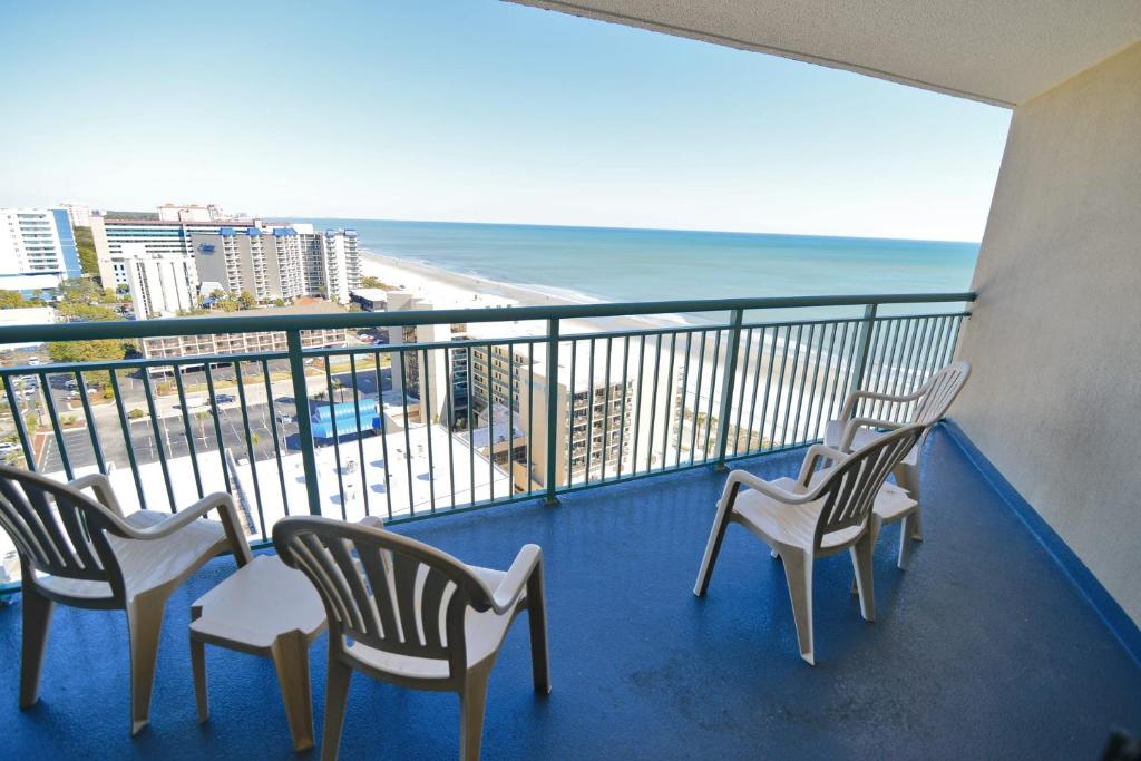 a balcony with chairs and a view of the beach at Paradise Ocean View at Top Resort w Lazy River in Myrtle Beach
