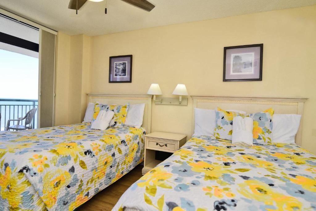 two beds sitting next to each other in a bedroom at Paradise Ocean View at Top Resort w Lazy River in Myrtle Beach