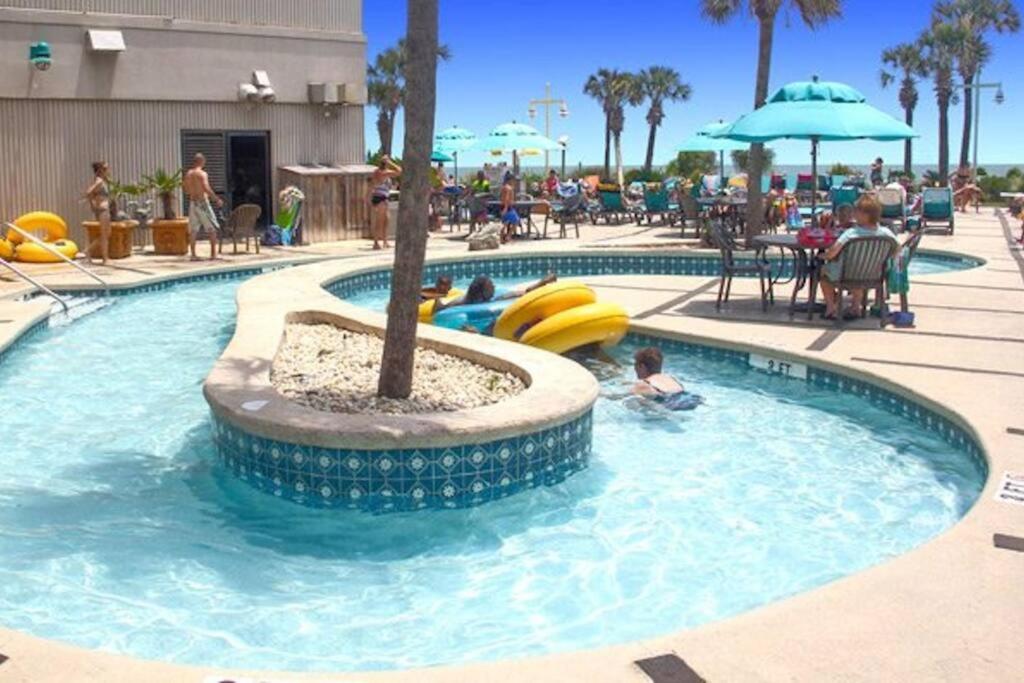 a pool at a resort with people playing in it at Paradise Ocean View at Top Resort w Lazy River in Myrtle Beach