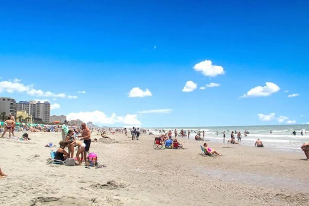 a large group of people on a beach at Paradise Ocean View at Top Resort w Lazy River in Myrtle Beach