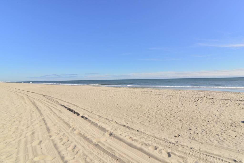 a beach with footprints in the sand and the ocean at Paradise Ocean View at Top Resort w Lazy River in Myrtle Beach