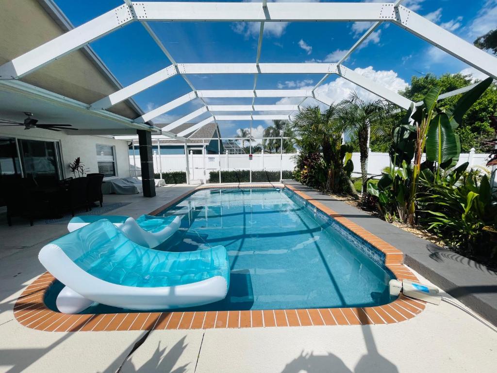 a swimming pool with a pool noodle in a house at PARADISE HOME NEAR IMG ACADEMY & SIESTA KEY BEACH in Bradenton