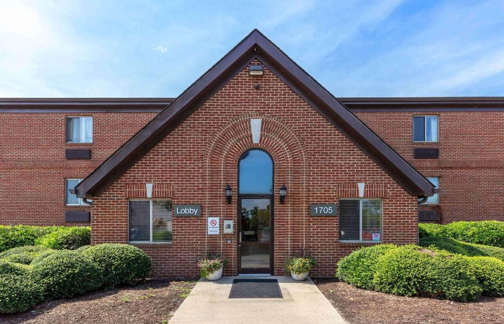 a red brick building with an arch doorway at Extended Stay America Select Suites - Greensboro - Wendover Ave in Greensboro