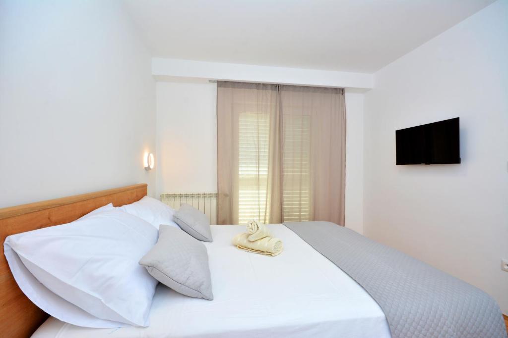 Posteľ alebo postele v izbe v ubytovaní Apartments Radeljić