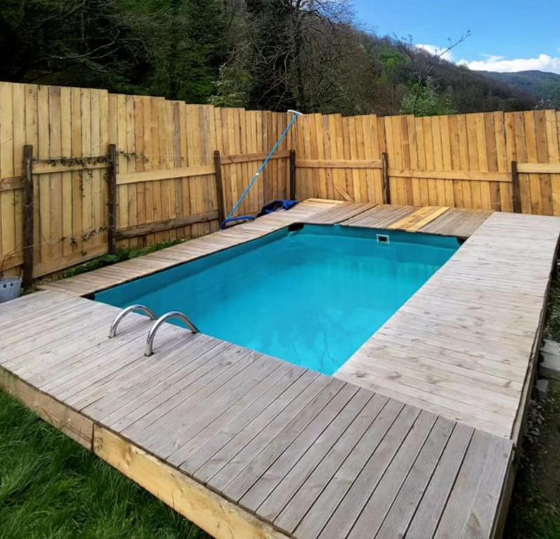 a small swimming pool with a wooden fence at İstanbuldere Glamping in Sapanca