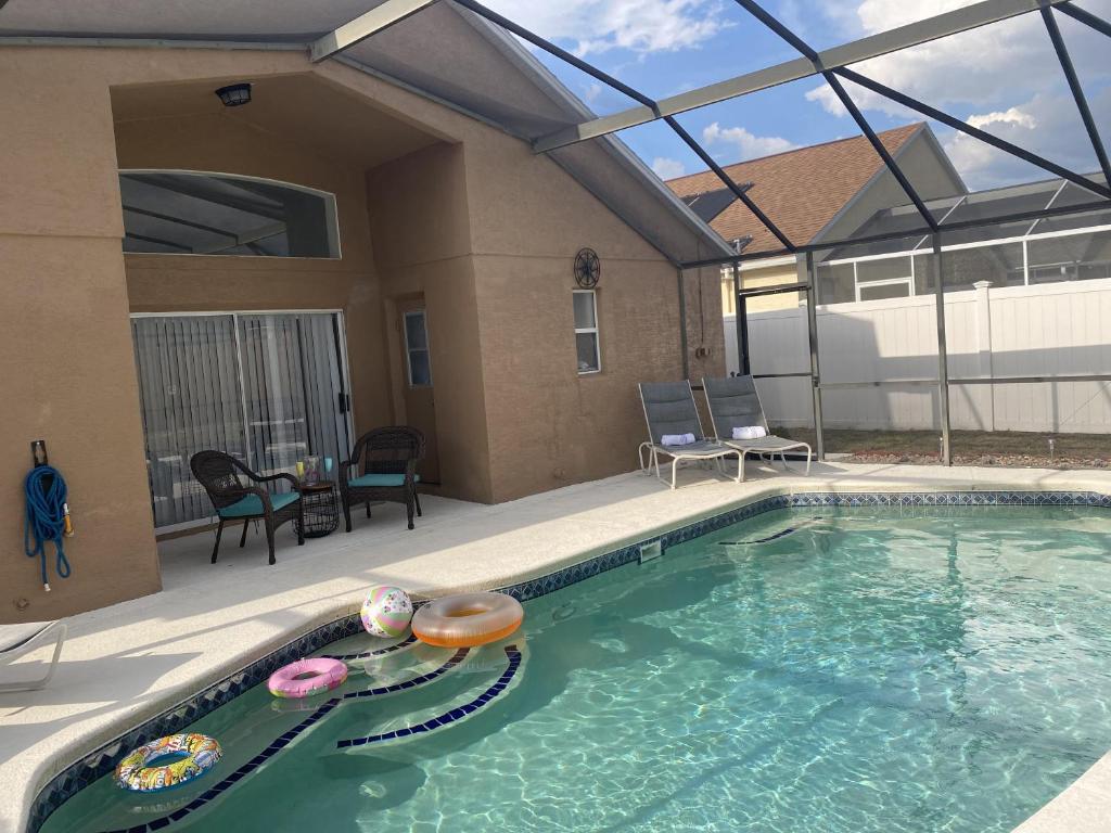 a swimming pool in a house with a patio at Home from Home 5 bedroom villa in Davenport