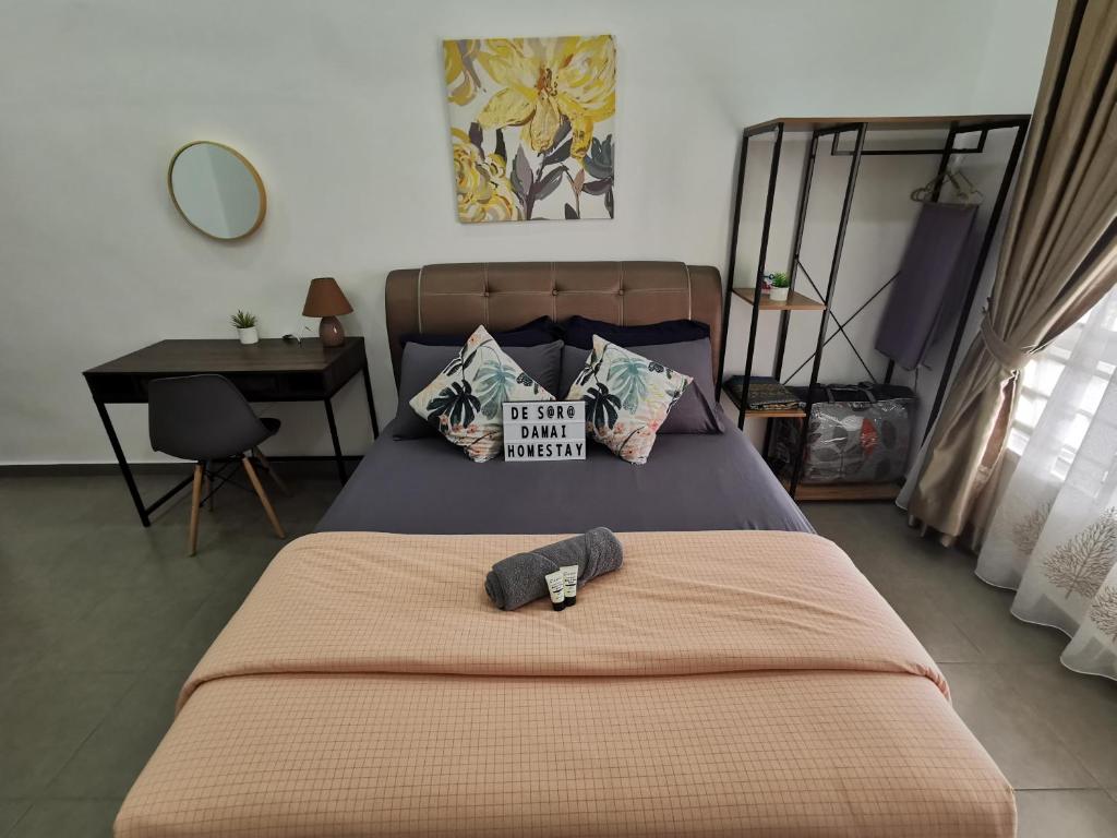 a bedroom with a bed with a hat on it at De'Sara Damai Homestay, Kuantan in Kuantan