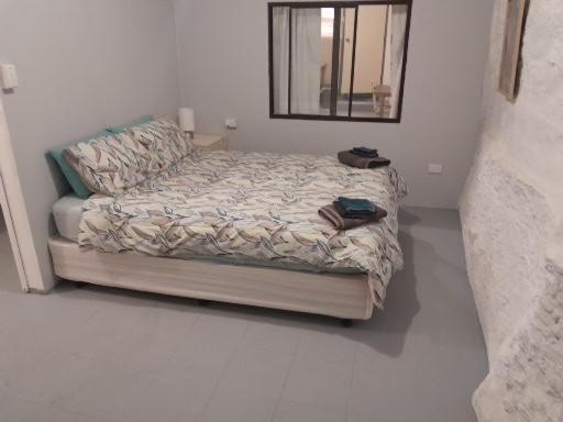 a bedroom with a bed and a mirror in it at Green Opal in Coober Pedy